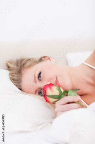 Photo: Blue eyed woman smelling a rose Blue eyed woman smelling a rose