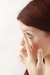 young woman with contact lense