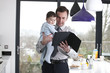 A father and baby son looking at a digital tablet