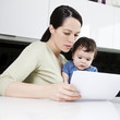 A mother and her baby son looking at paperwork