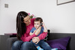 A mother and her baby son listening on a mobile phone