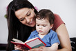 A mother and her baby son reading a book