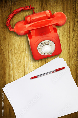 Photo: red phone and paper red phone and paper