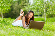Young woman using laptop in park Young woman using laptop in park
