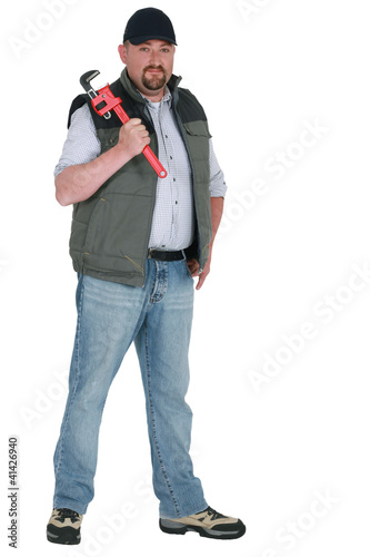 Photo: Worker with an adjustable pipe wrench Worker with an adjustable pipe wrench