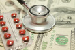health care costs - Stethoscope on money background and pills