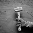 hammer man with gloves in grunge cement background hammer man with gloves in grunge cement background