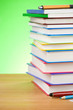 pile of books and pen on green pile of books and pen on green