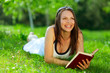 Beautiful young woman reading a book in park Beautiful young woman reading a book in park