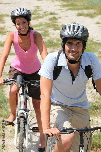 Photo: Couple enjoying leisurely bike ride Couple enjoying leisurely bike ride
