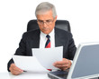 Businessman at desk with computer and papers Businessman at desk with computer and papers