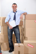 Courrier stood by stacked boxes