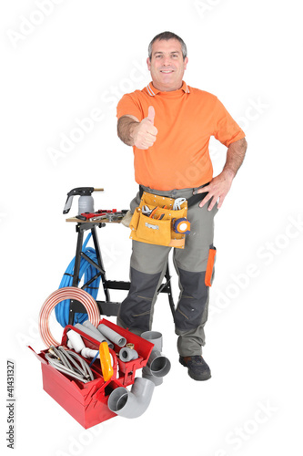 Photo: handyman doing thumbs up by a lot of tools and materials handyman doing thumbs up by a lot of tools and materials