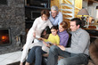 Family gathered together looking at photographs