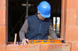 bricklayer taking measurements