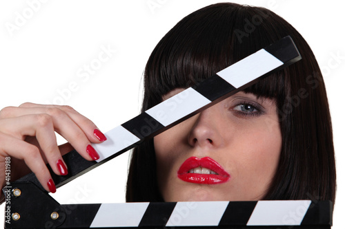 Photo: Attractive woman with a film set clapboard Attractive woman with a film set clapboard