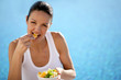 Woman eating fruit in a swimming pool