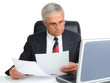 Businessman at desk with computer and papers Businessman at desk with computer and papers