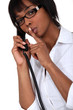 canvas print picture - woman on the phone making a sign for silence