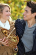 Couple gathering chestnuts in basket