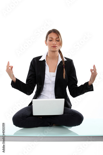 Photo: Businesswoman, sat in yoga position Businesswoman, sat in yoga position