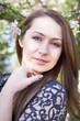Beautiful young woman in spring garden