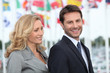 Couple of executives with flags in the background