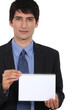 Businessman displaying notepad