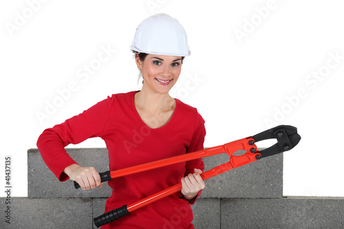 Photo: Woman holding large pliers Woman holding large pliers