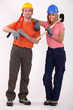 A team of workers holding tools on their shoulders A team of workers holding tools on their shoulders