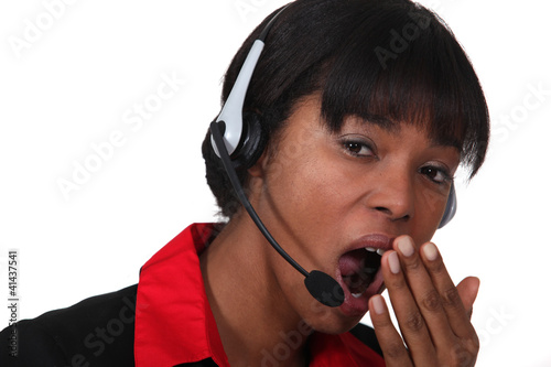 Photo: Woman with headset yawning Woman with headset yawning