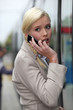 blonde woman at phone having an anxious face expression