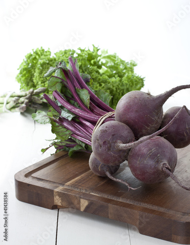 Photo: Fresh beetroot from farmers market on dark wooden board Fresh beetroot from farmers market on dark wooden board