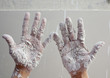 Astist plastering man hands with cracked plaster