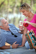 Middle-aged couple having fancy picnic