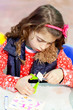Photo en ligne au meilleur prix little kid girl working at school doing workshop