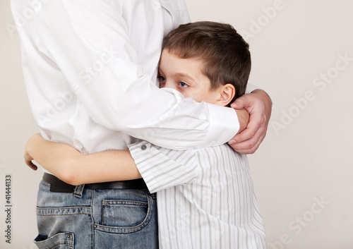 Photo: Father comforts a sad child Father comforts a sad child