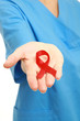 A young nurse with an aids ribbon, isolated on white