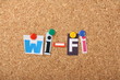 The word Wi-Fi in letters pinned to a cork board