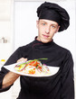 chef in black uniform offer salad chef in black uniform offer salad