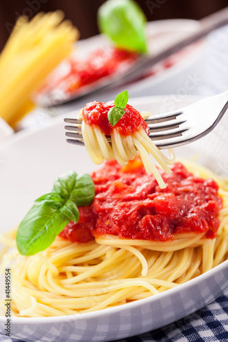 Photo: Spaghetti with Tomato Sauce on classical home table Spaghetti with Tomato Sauce on classical home table
