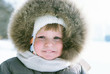 Happy smiling boy in winter clothes