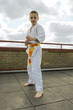 judoka teen boy training judo on the sky background
