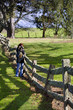 Female photographer at old post and rail fence