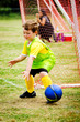 Young child boy playing soccer during organized league game Young child boy playing soccer during organized league game