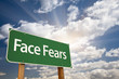 Face Fears Green Road Sign and Clouds