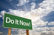 Do It Now! Green Road Sign and Clouds