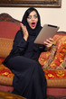 arabian lady with hijab shocked while using a Pad
