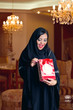 arabian lady wearing hijab happy for receiving a gift