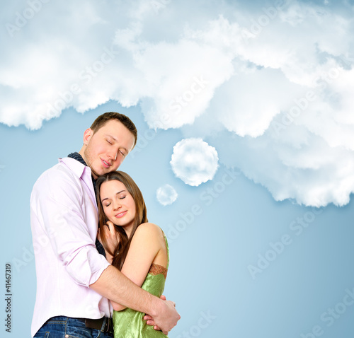 Photo: Portrait of young couple standing together and embracing Portrait of young couple standing together and embracing